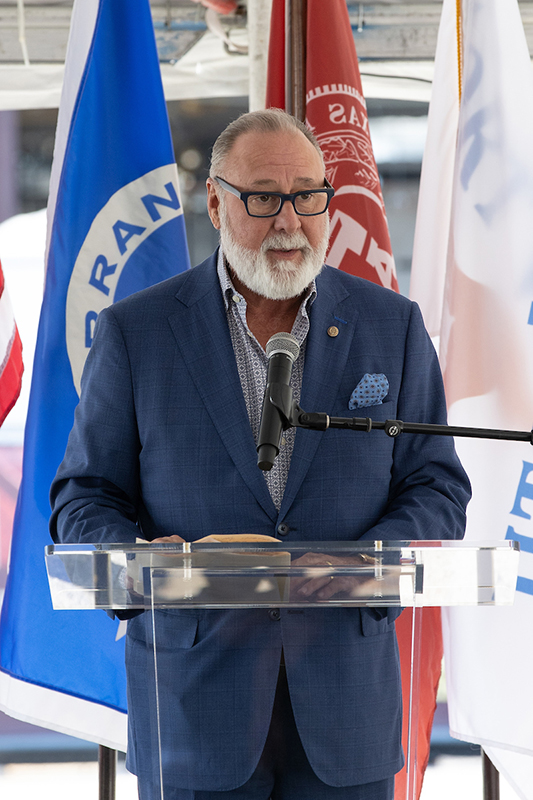 Mike Hernandez III speaking at a a podium.